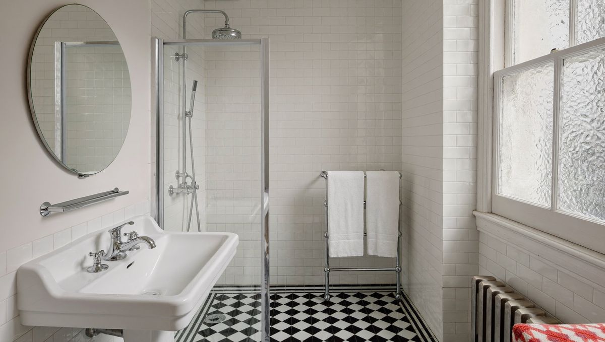 Generated illustration: a clean, tiled bathroom in a London period conversion.