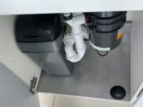 The cupboard under the sink after the clean